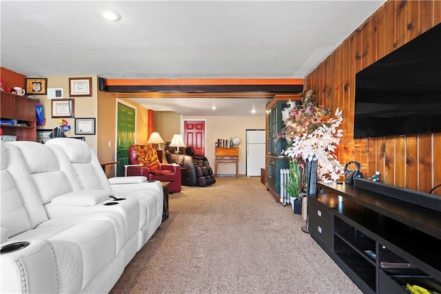 living room with wooden walls and light carpet