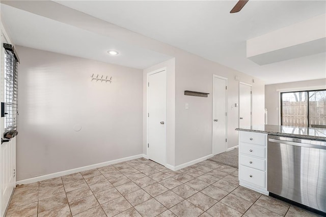 kitchen featuring light tile patterned floors, baseboards, white cabinetry, ceiling fan, and stainless steel dishwasher