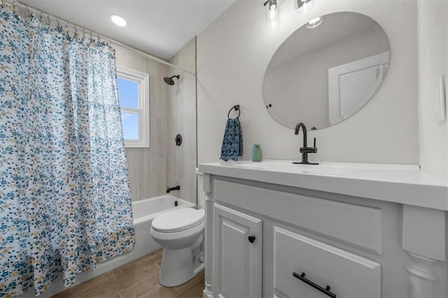 full bath featuring shower / bath combination with curtain, toilet, vanity, and wood tiled floor