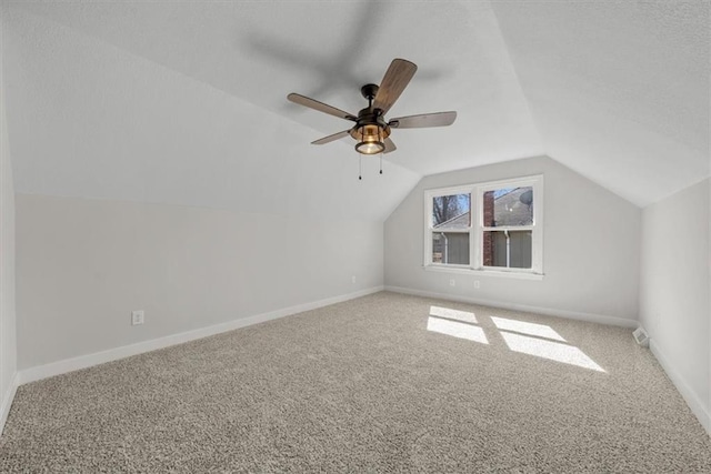 additional living space featuring lofted ceiling, a ceiling fan, baseboards, and carpet floors