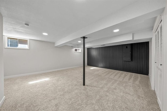 basement featuring recessed lighting, baseboards, and carpet