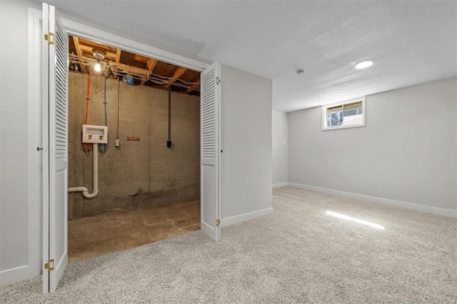 basement with baseboards and carpet