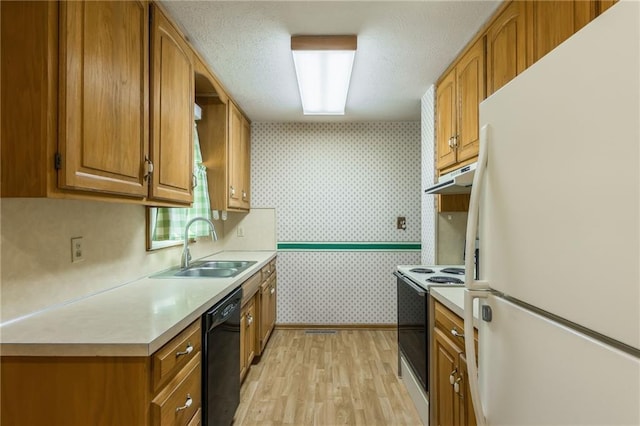 kitchen featuring electric range, wallpapered walls, freestanding refrigerator, light countertops, and dishwasher