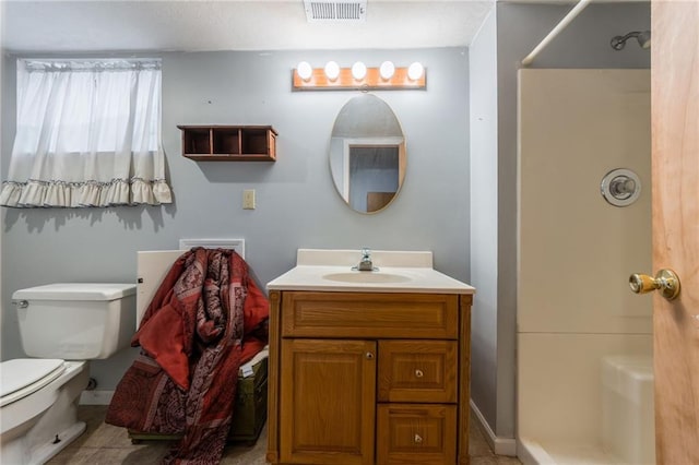 bathroom featuring vanity, baseboards, visible vents, walk in shower, and toilet