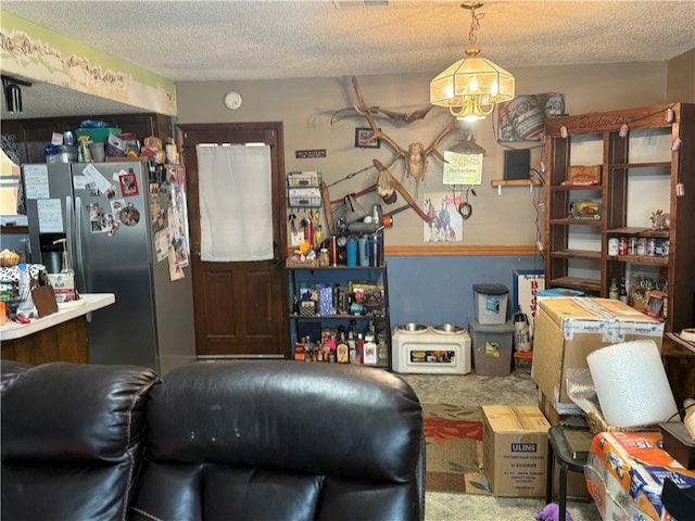 living room with visible vents, a textured ceiling, and carpet