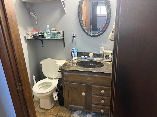 bathroom with toilet and vanity