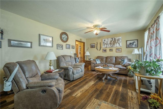 living room with dark wood-type flooring and a ceiling fan