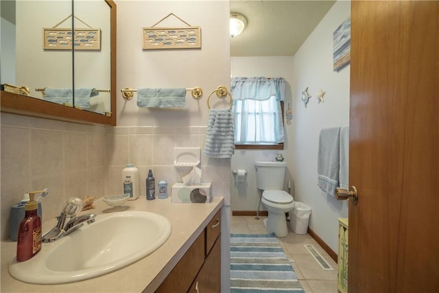 bathroom featuring vanity, visible vents, tile patterned floors, toilet, and tile walls