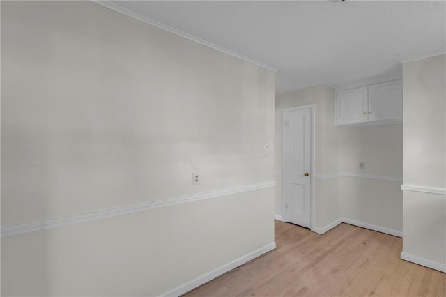 unfurnished room featuring baseboards and light wood-style flooring