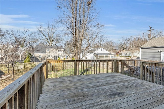 wooden terrace featuring fence and a residential view