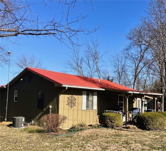 view of property exterior with metal roof and central AC