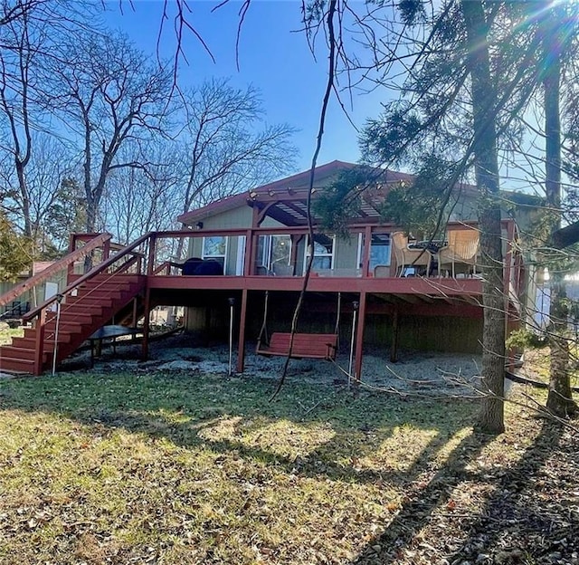 back of property featuring stairway and a wooden deck