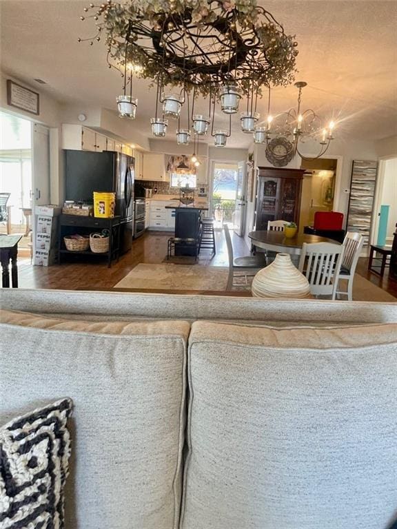 living room with a notable chandelier and wood finished floors