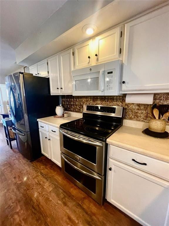 kitchen with decorative backsplash, appliances with stainless steel finishes, white cabinets, and light countertops