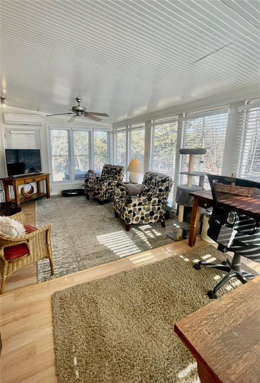 sunroom featuring a wealth of natural light and ceiling fan