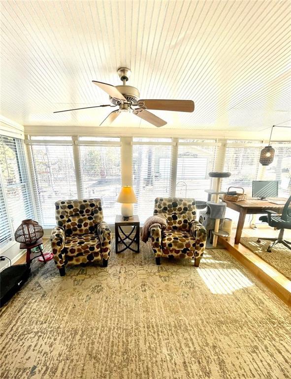 sunroom with a wealth of natural light and a ceiling fan