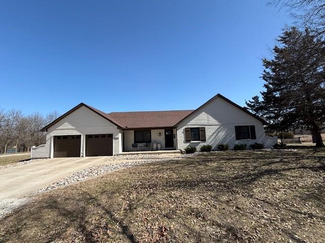 view of front of home featuring concrete driveway and an attached garage