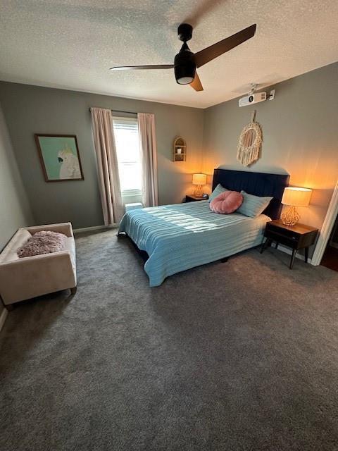 bedroom with a textured ceiling, ceiling fan, and carpet flooring