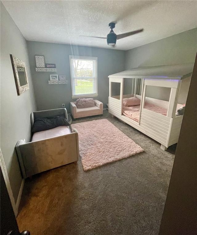 bedroom with a textured ceiling, a ceiling fan, and carpet floors