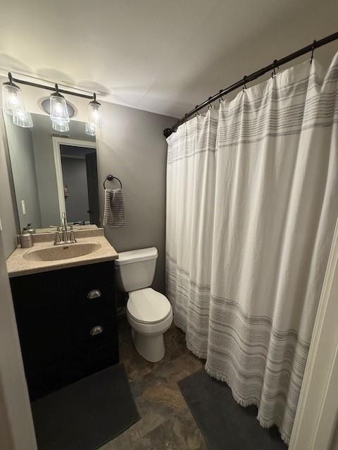 bathroom featuring vanity, toilet, and a shower with curtain