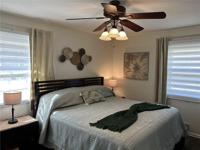 bedroom with visible vents and a ceiling fan