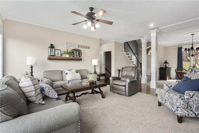 16520 NW 178th St, Platte City, MO 64079 - carpeted living area with decorative columns, stairs, a ceiling fan, crown molding, and a chandelier