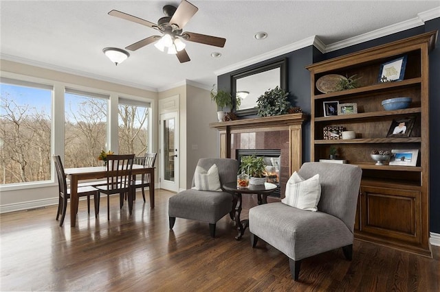 16520 NW 178th St, Platte City, MO 64079 - living area featuring ceiling fan, dark wood-style floors, a tiled fireplace, and ornamental molding