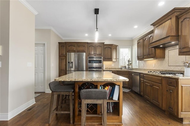 16520 NW 178th St, Platte City, MO 64079 - kitchen featuring appliances with stainless steel finishes, tasteful backsplash, a center island, light stone countertops, and dark wood finished floors