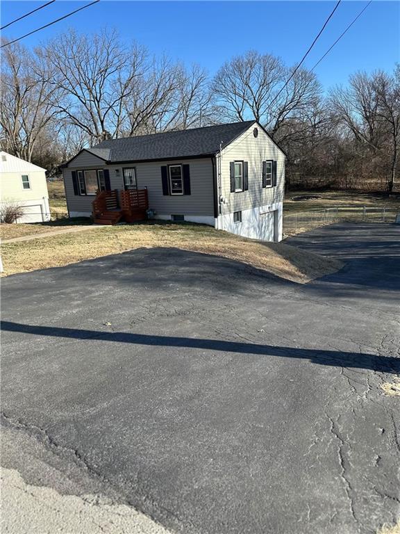 view of front of property featuring roof with shingles