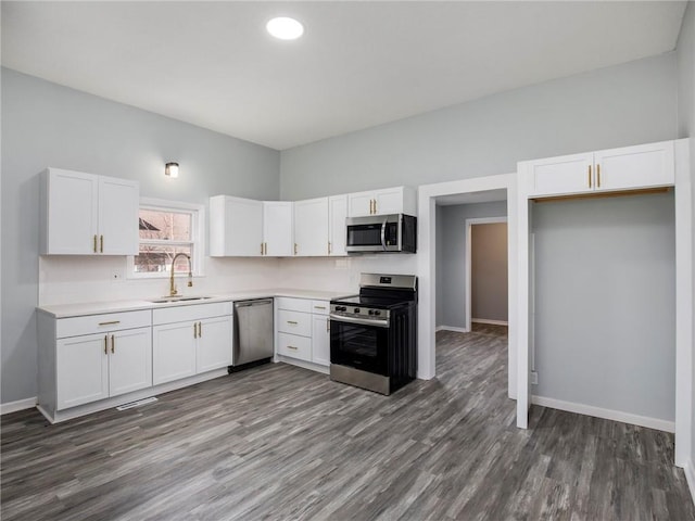 kitchen with a sink, stainless steel appliances, and white cabinets