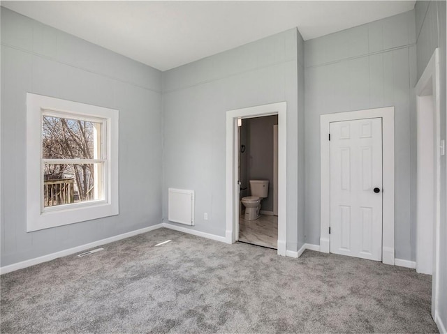 unfurnished bedroom featuring visible vents, baseboards, connected bathroom, and carpet flooring