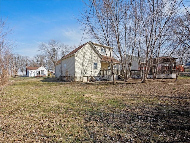 view of side of property featuring a lawn and fence