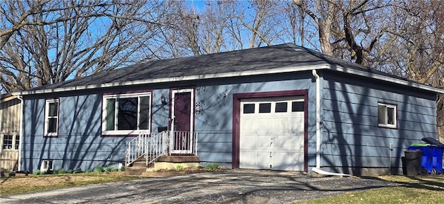 view of front facade featuring aphalt driveway and an attached garage