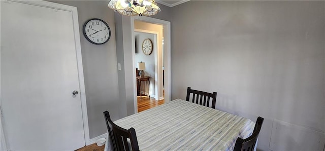 dining space with baseboards and an inviting chandelier