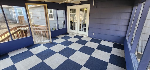 unfurnished sunroom featuring ceiling fan