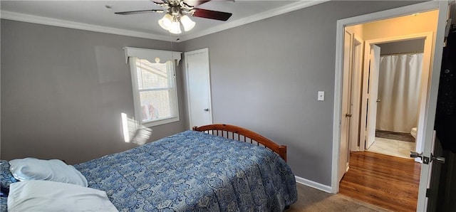 bedroom with a ceiling fan, crown molding, carpet, and baseboards