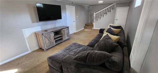 living area featuring baseboards, light colored carpet, and stairs