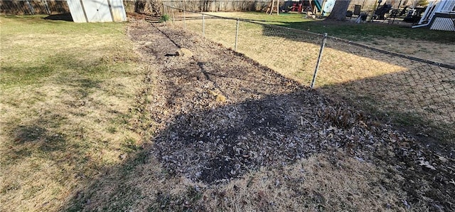 view of yard with an outbuilding, a storage shed, and a fenced backyard