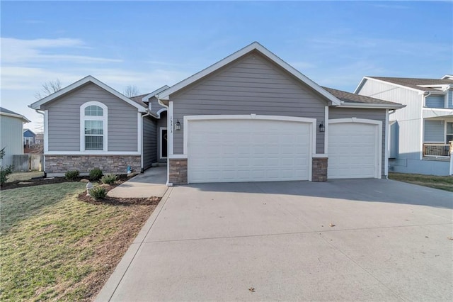 single story home with stone siding, driveway, a front yard, and a garage