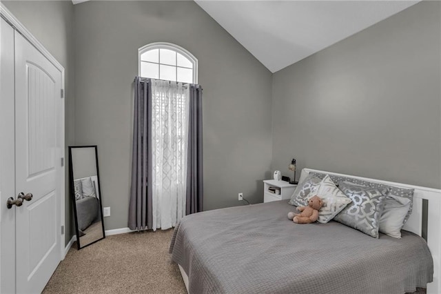 bedroom with light carpet, baseboards, and vaulted ceiling