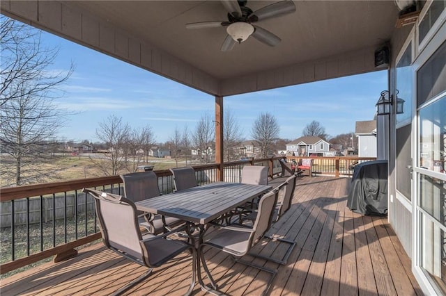 deck with outdoor dining area and ceiling fan