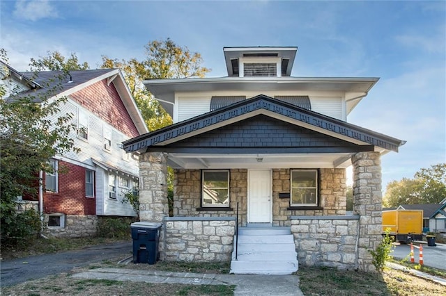 american foursquare style home with a porch