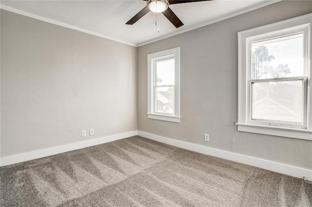 unfurnished room with crown molding, a ceiling fan, baseboards, and carpet floors