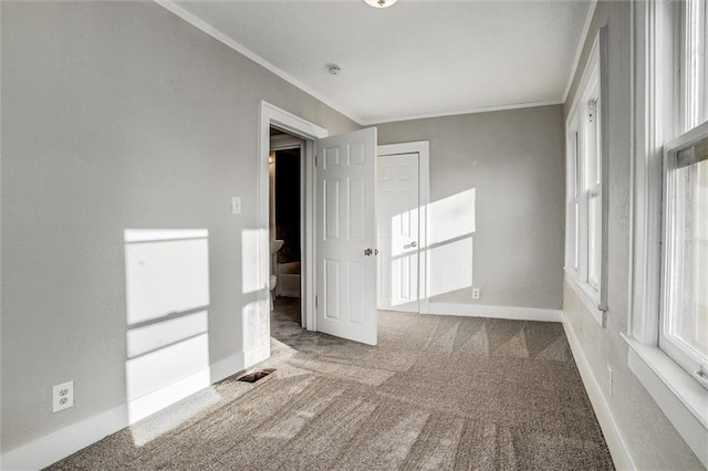 carpeted spare room with baseboards and ornamental molding