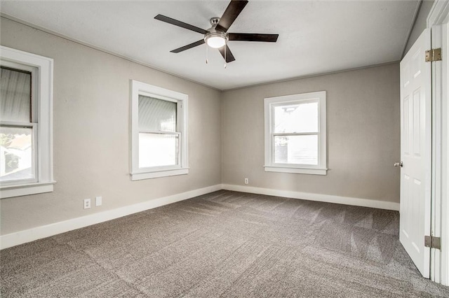 empty room with plenty of natural light, baseboards, and carpet