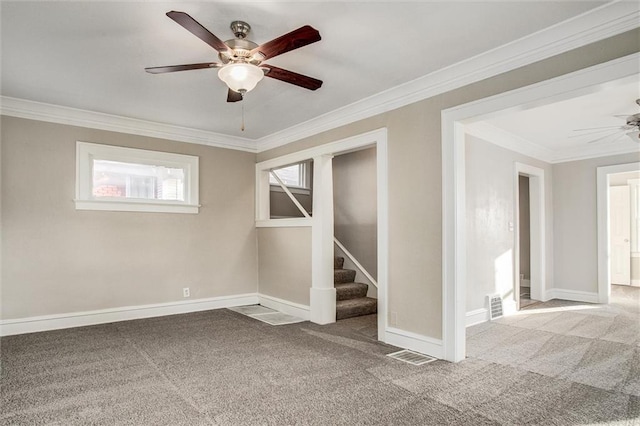 carpeted empty room featuring visible vents, ornamental molding, and stairway