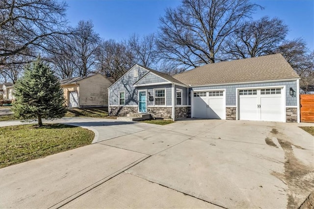 view of front of property featuring stone siding, concrete driveway, a garage, and roof with shingles