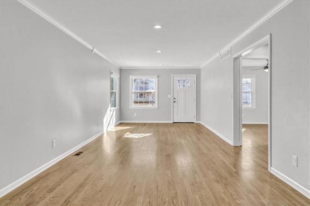 entryway with baseboards and ornamental molding