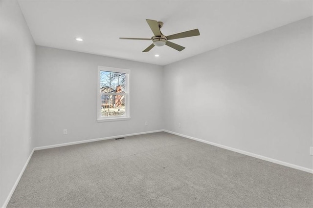 carpeted spare room featuring visible vents, recessed lighting, a ceiling fan, and baseboards