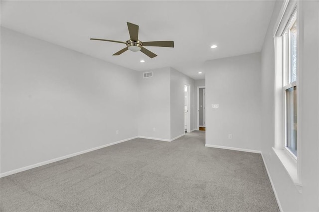 carpeted spare room with visible vents, recessed lighting, baseboards, and ceiling fan